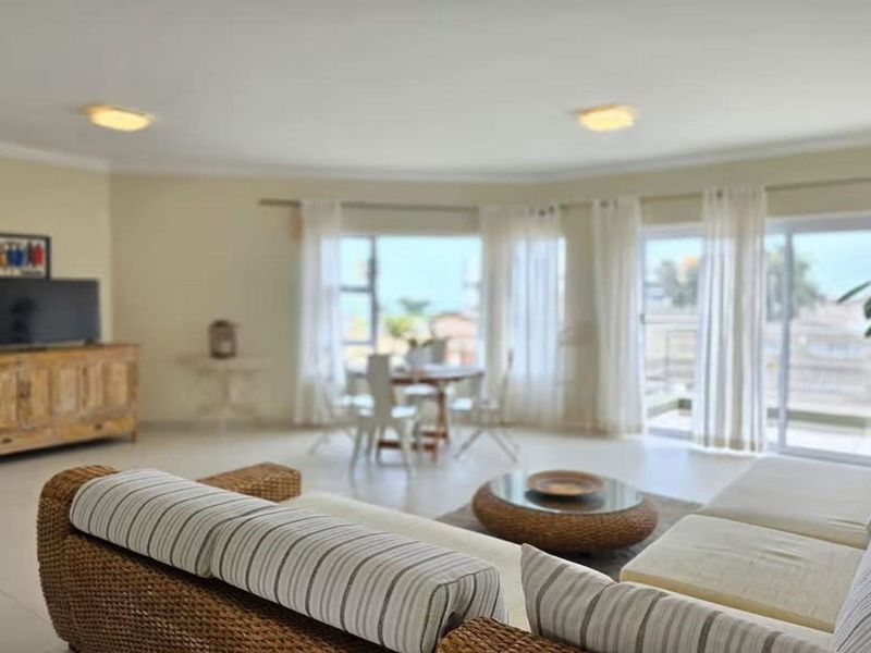 Spacious living area featuring large sliding glass doors that provide natural light and access to an outdoor balcony space.