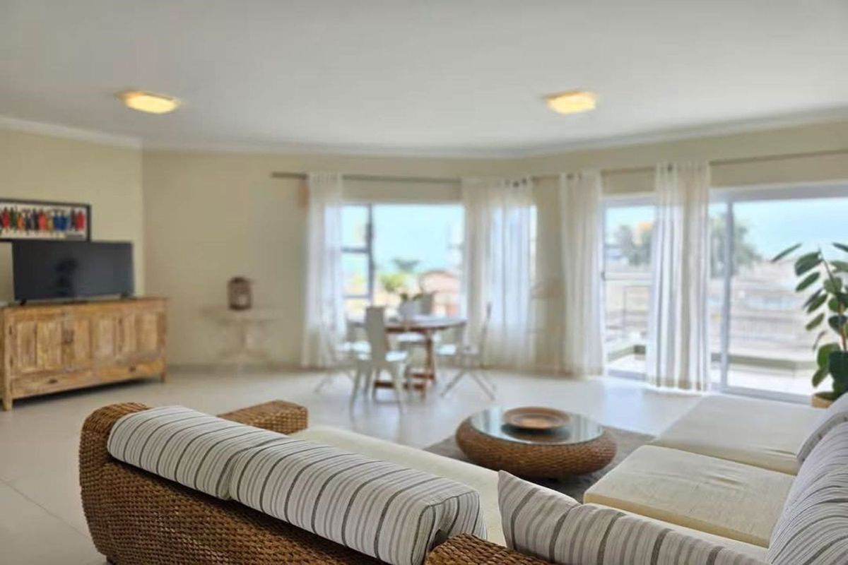 Spacious living area featuring large sliding glass doors that provide natural light and access to an outdoor balcony space.