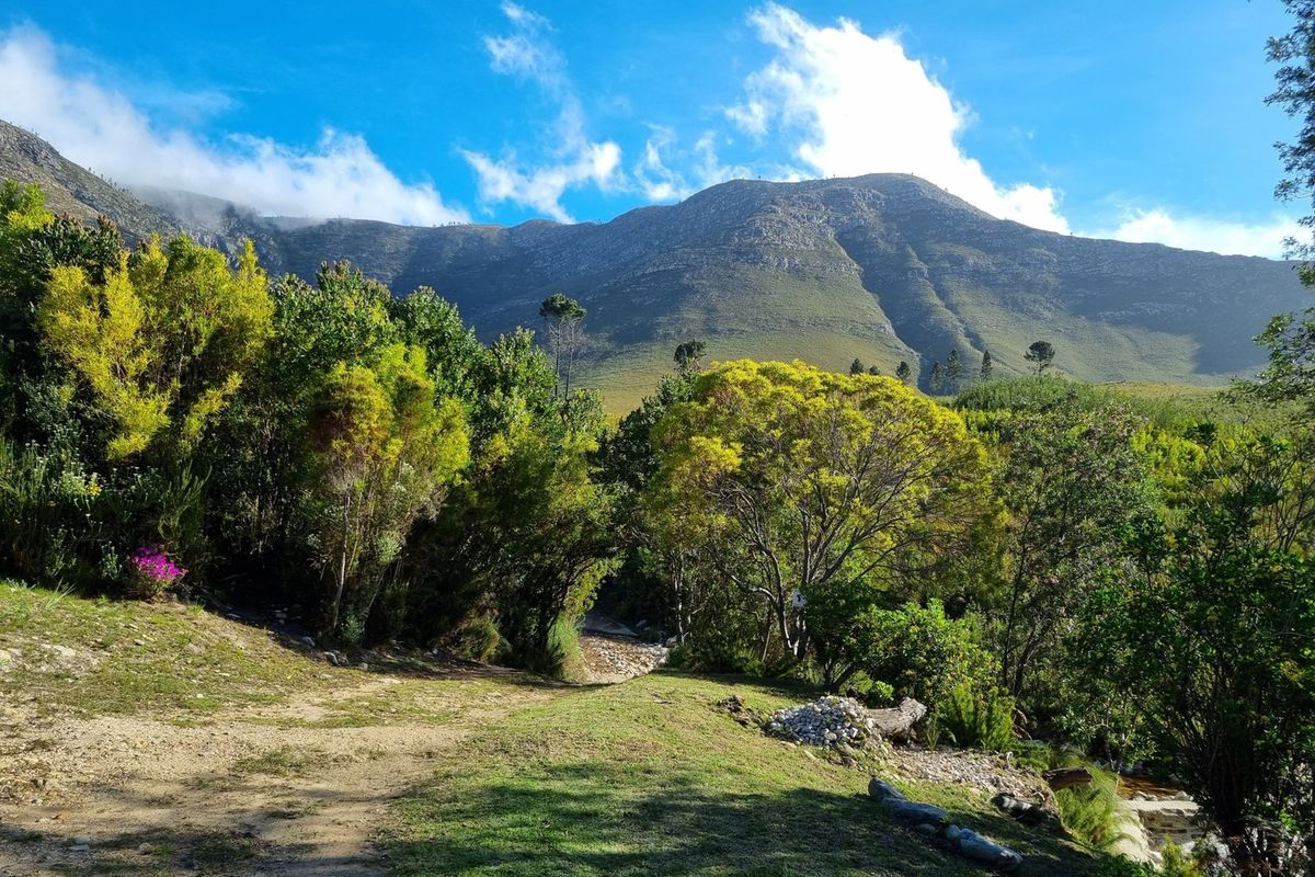 A scenic view of the surrounding mountain range and natural landscape, showcasing the property's tranquil and picturesque rural setting.