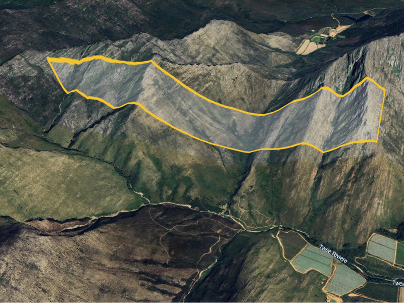 An aerial view of the farm property showcasing the expansive mountainous landscape and surrounding agricultural fields.