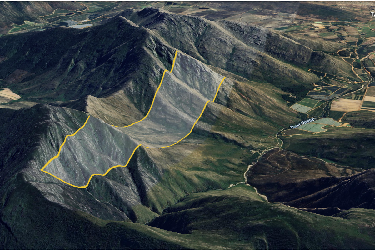 An aerial view of the expansive mountainous landscape and natural terrain surrounding the property.