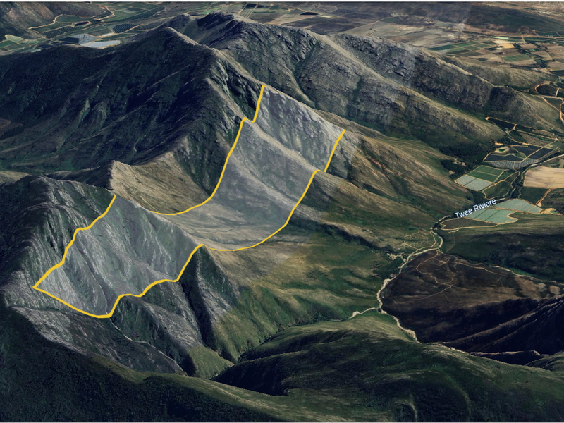 An aerial view of the expansive mountainous landscape and natural terrain surrounding the property.
