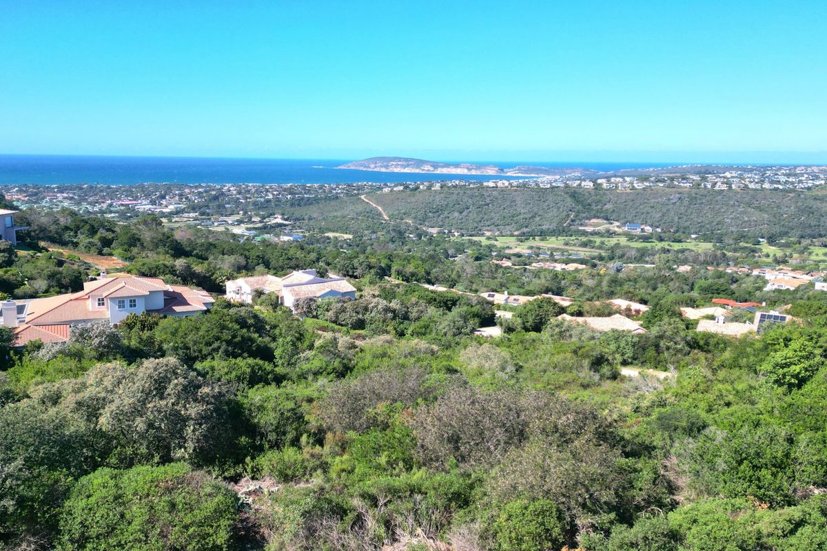 An elevated panoramic view overlooking the surrounding coastal landscape, residential properties, and the ocean in the distance.