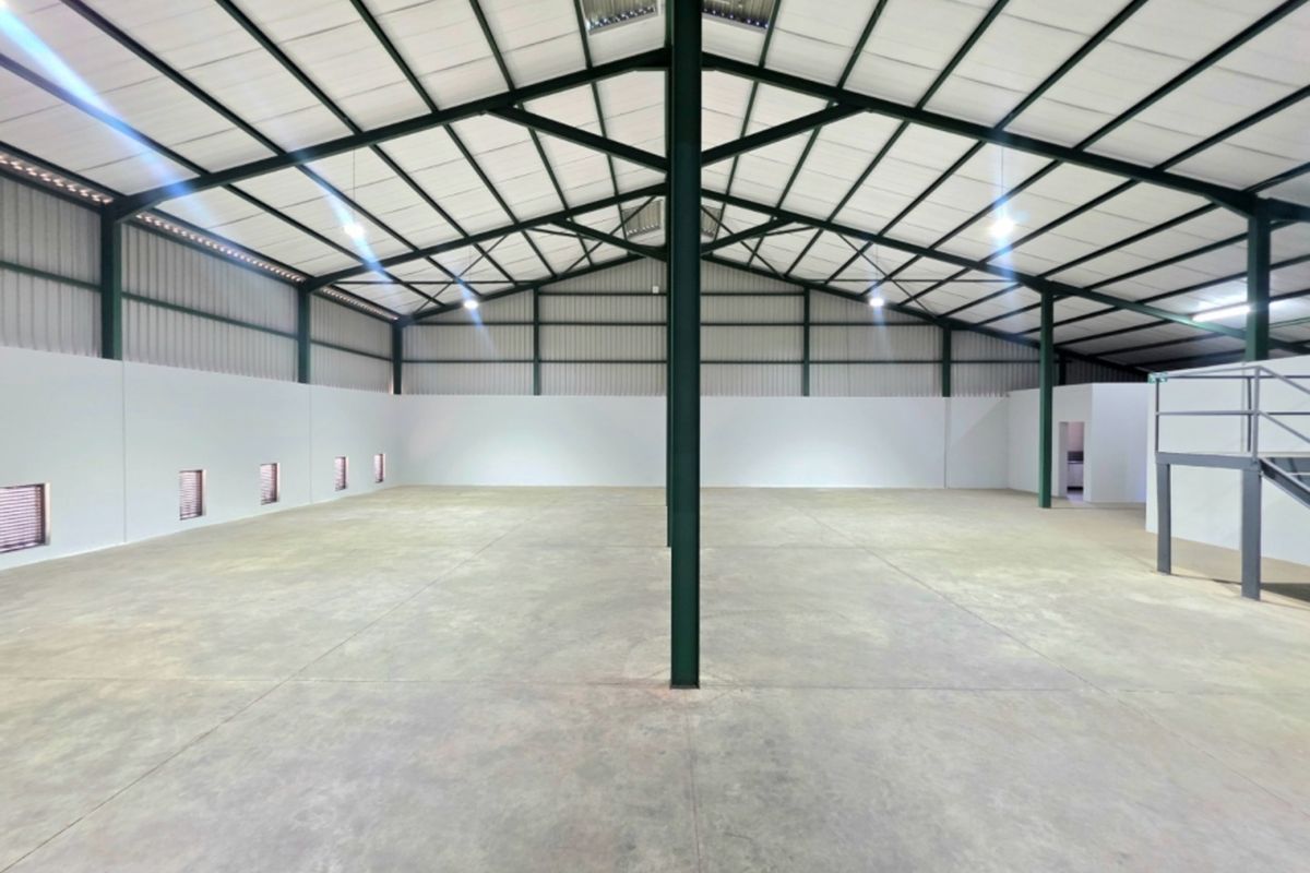 Spacious industrial warehouse featuring a high-clearance steel portal frame, polished concrete flooring, and an integrated mezzanine level.