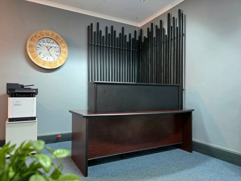 Professional office reception area featuring a modern timber slat wall accent and a built-in reception desk.