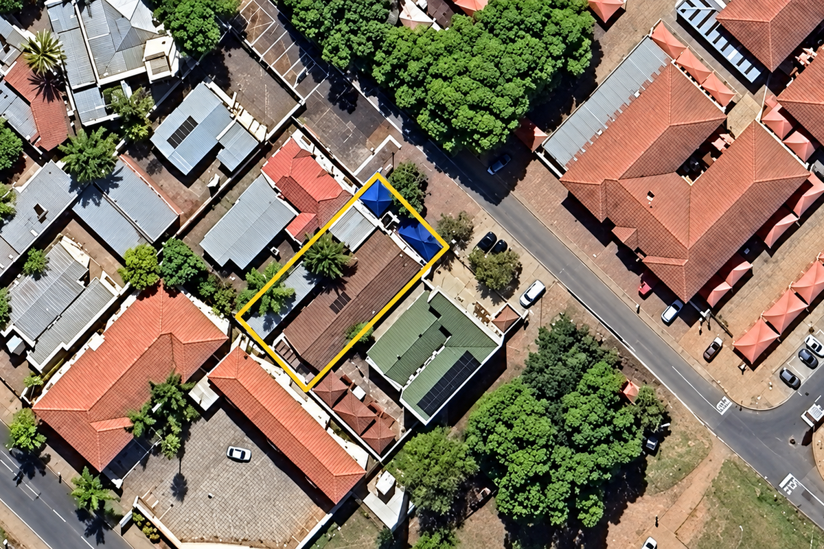 Aerial view of the office property highlighting the building footprint, roof structure, and surrounding parking facilities within the commercial complex.