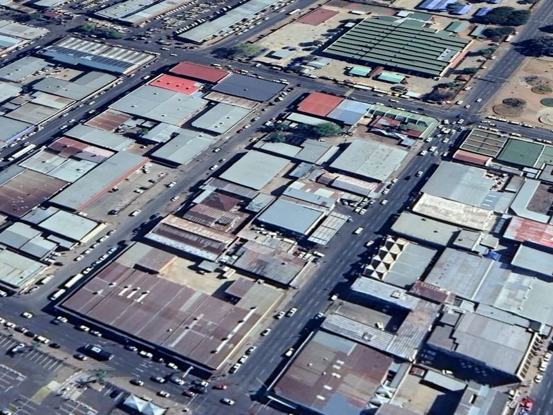 An aerial view of a commercial industrial district showing multiple warehouse buildings with metal roofing and surrounding road infrastructure.