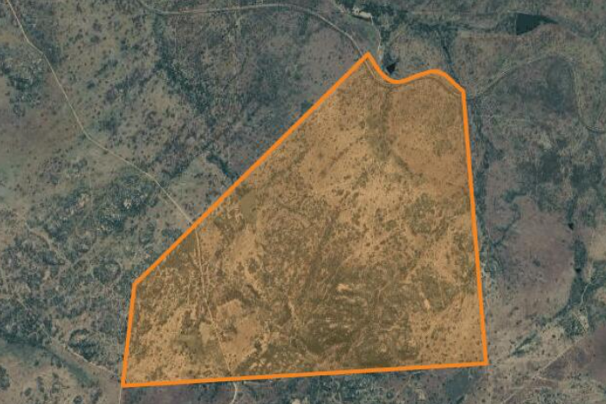 An aerial view showing the expansive land parcel and its demarcated boundaries within the surrounding rural landscape.
