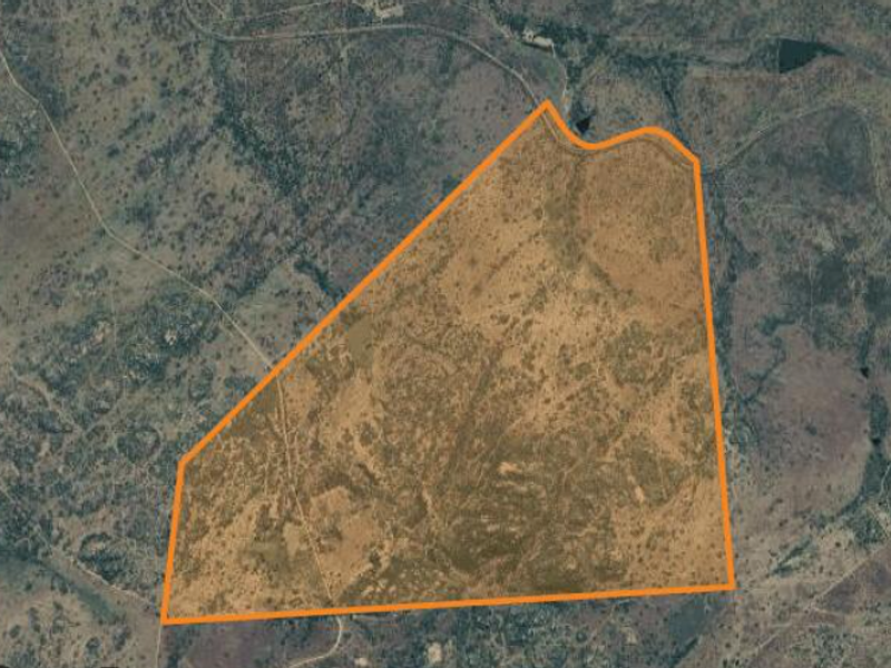 An aerial view showing the expansive land parcel and its demarcated boundaries within the surrounding rural landscape.