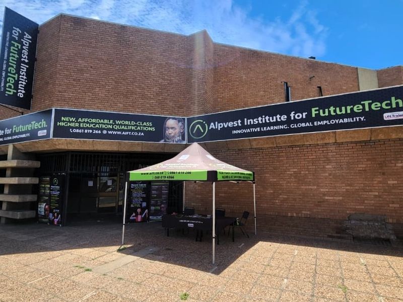 Front exterior view of the Alpvest Institute for FutureTech building, featuring a brick facade and prominent signage.