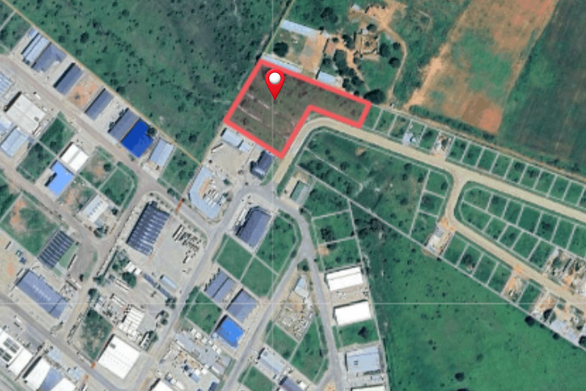 Aerial view of a vacant commercial land plot situated within an established industrial or commercial development area.