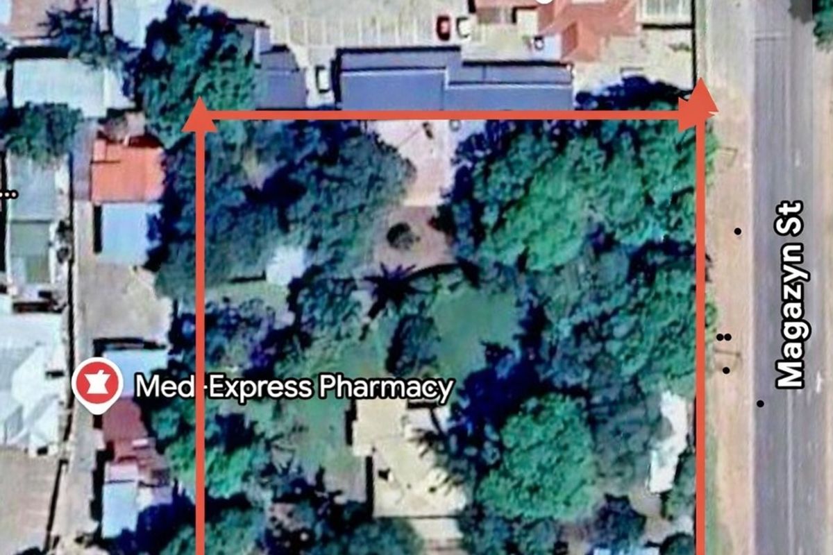 An aerial satellite view showing the property boundaries, surrounding street layout, and nearby commercial landmarks.