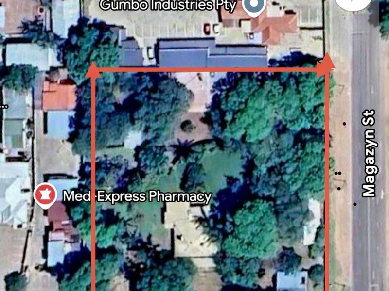 An aerial satellite view showing the property boundaries, surrounding street layout, and nearby commercial landmarks.