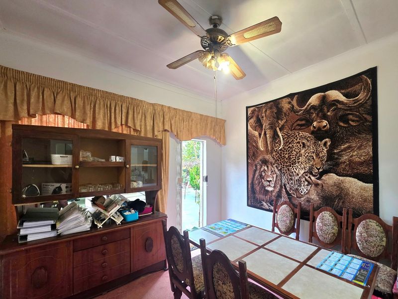 A dining room featuring a ceiling fan, built-in cabinetry, and direct access to the outdoor area through a sliding door.