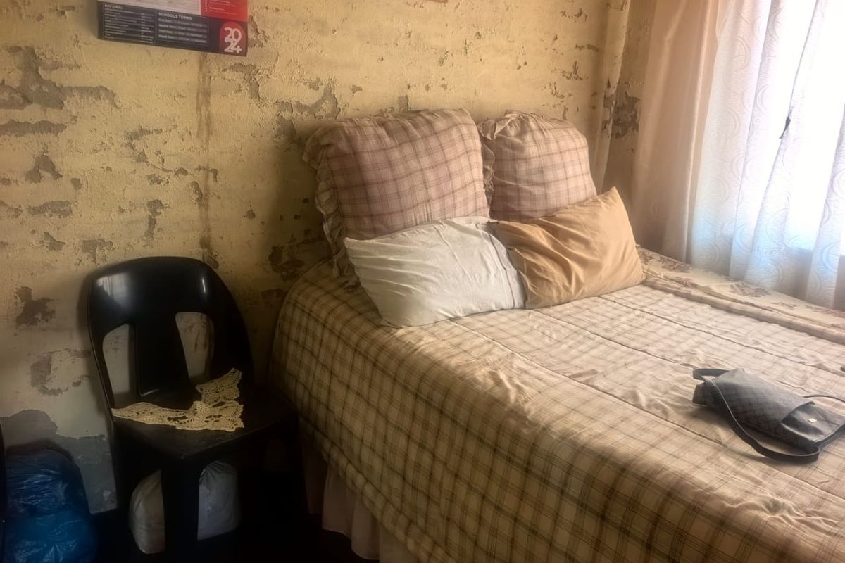 A bedroom featuring significant wall surface deterioration requiring plaster repair and repainting to restore the space.