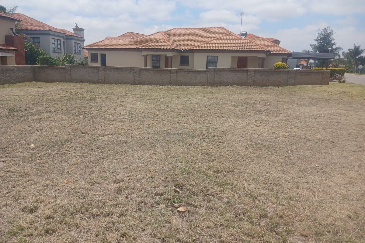 A vacant residential plot of land featuring a boundary wall, offering a clear space for potential development.