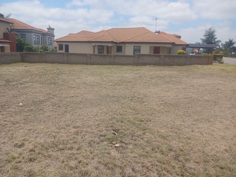 A vacant residential plot of land featuring a boundary wall, offering a clear space for potential development.