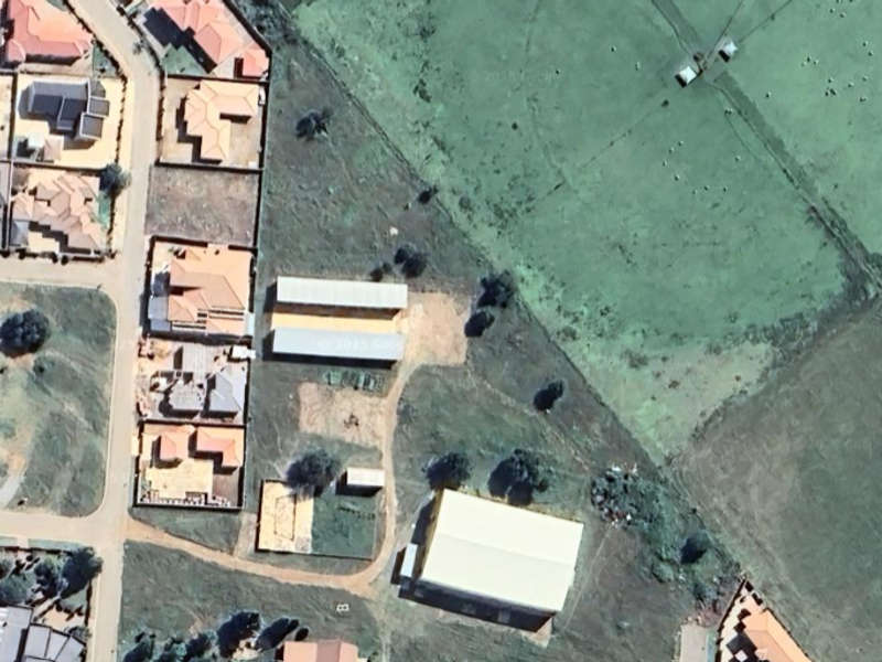 Aerial view of the industrial property site showing multiple warehouse structures, access roads, and surrounding land.