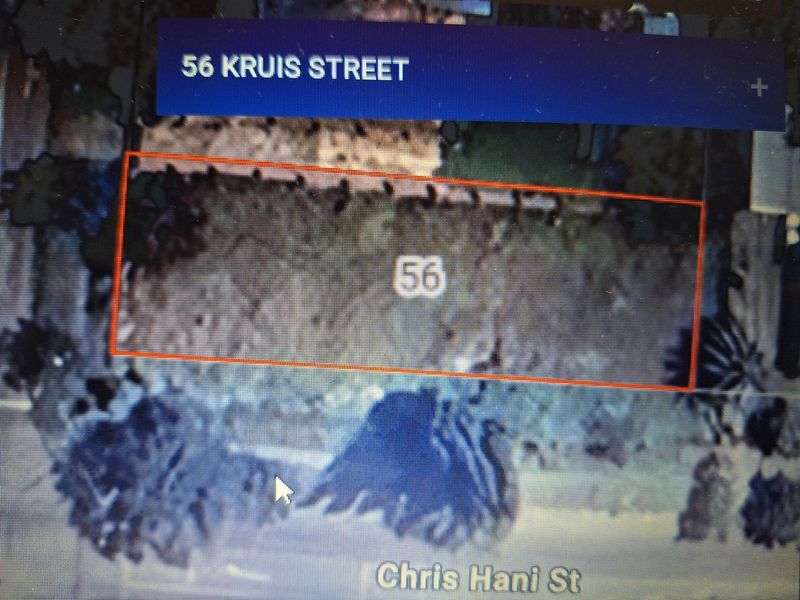 An aerial view of the vacant commercial land plot located at 56 Kruis Street, showing the property boundaries and surrounding area.