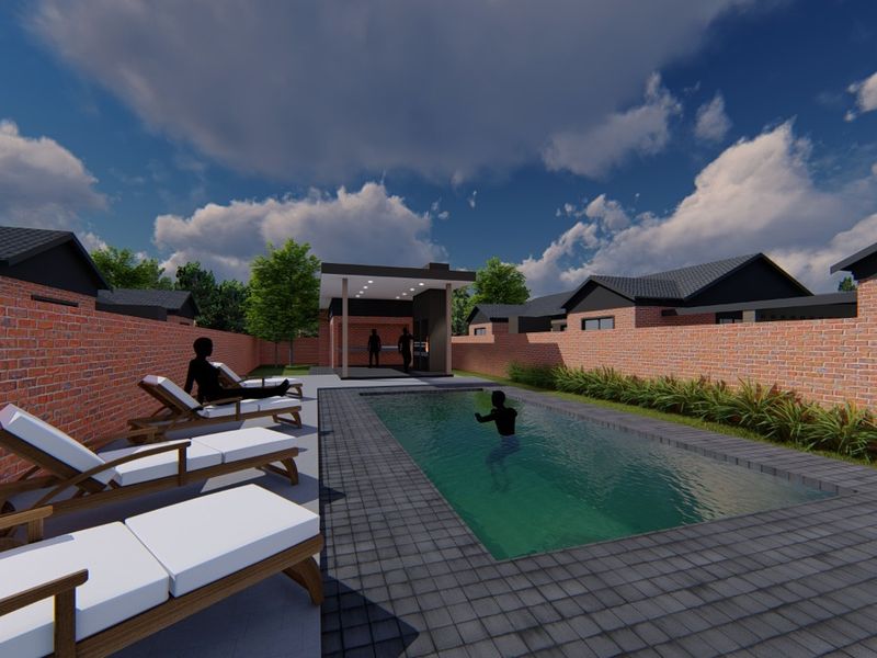 A modern outdoor pool area featuring a rectangular swimming pool, paved decking, and a covered patio structure enclosed by brick boundary walls.