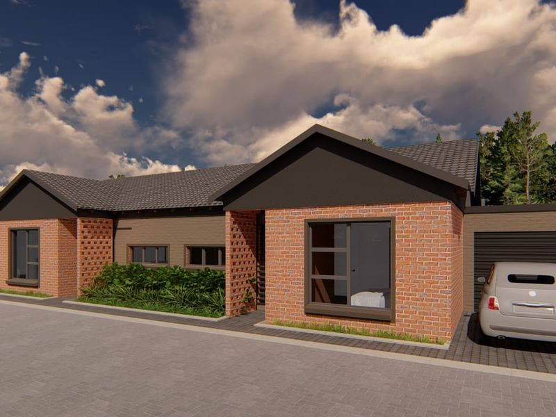 Modern townhouse exterior featuring a classic brick facade, tiled roof, and a paved driveway with integrated garage access.