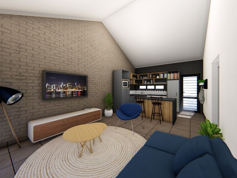 Modern open-plan living area featuring a vaulted ceiling, exposed brick feature wall, and a contemporary kitchen with a central island.