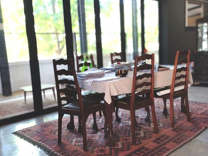 Dining area featuring polished concrete floors and large glass sliding doors that provide ample natural light and access to the outdoor space.
