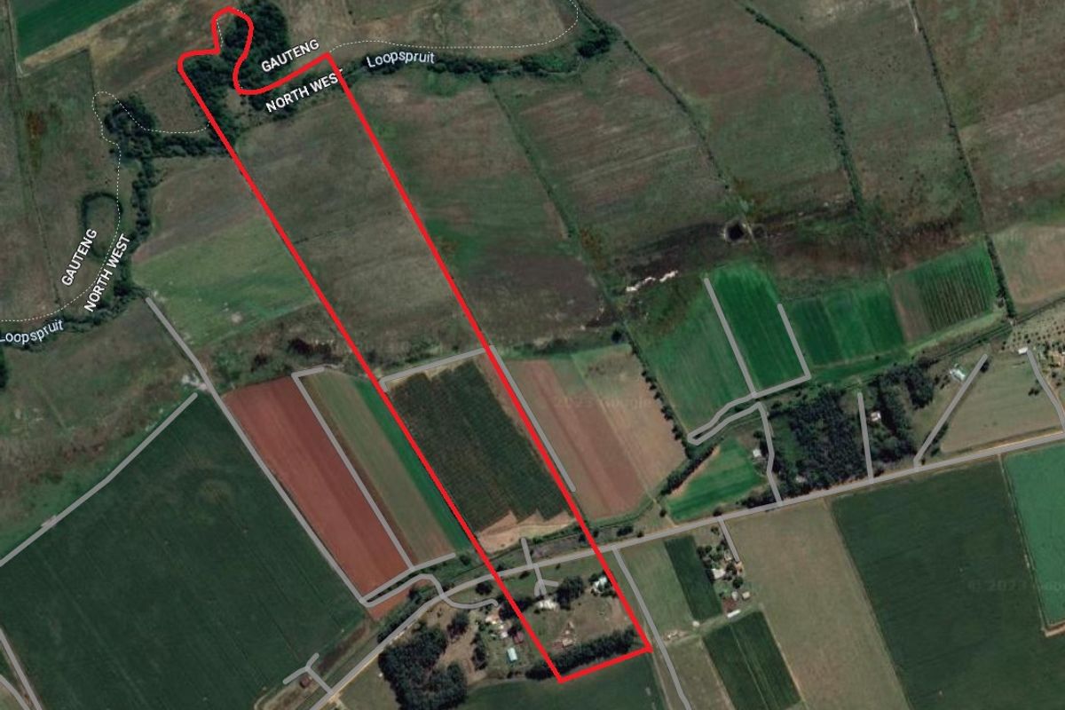 Aerial view of a small holding property showing the land boundaries, agricultural fields, and access road infrastructure.
