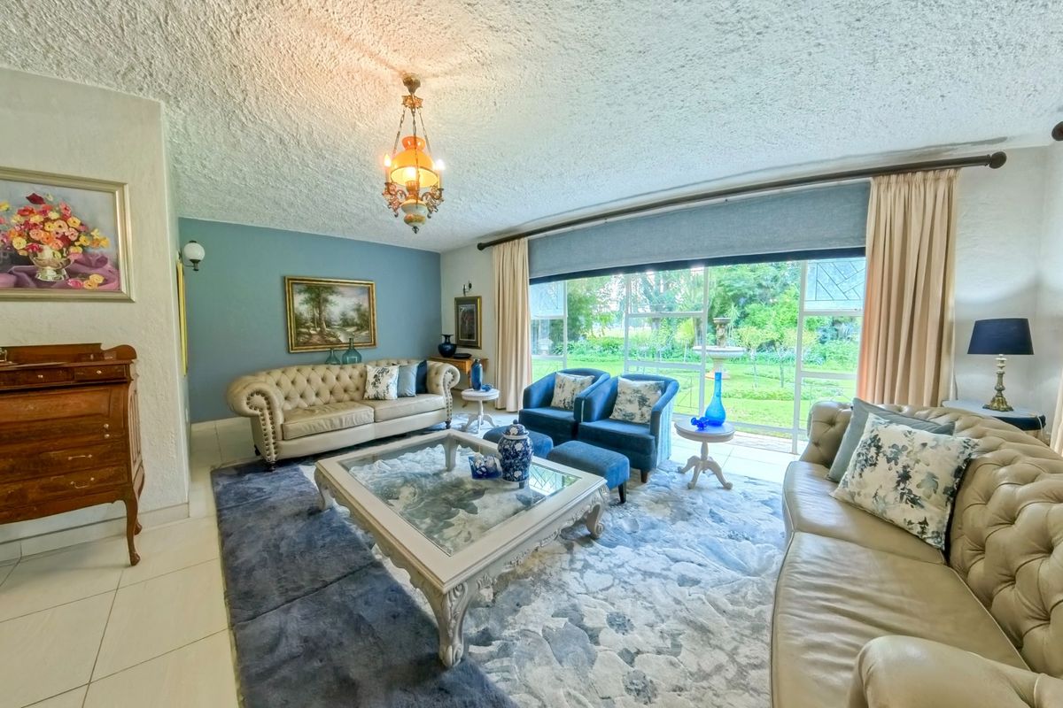 Spacious living room featuring large sliding glass doors that provide natural light and direct access to the garden area.
