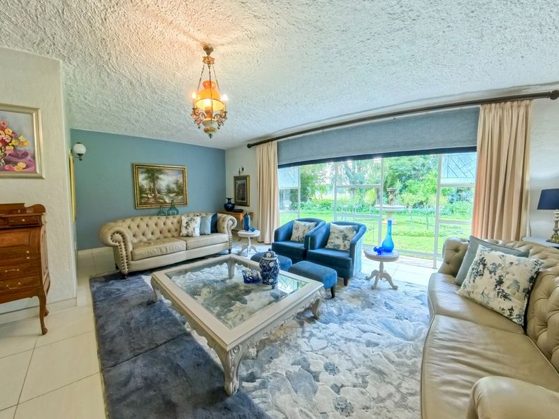 Spacious living room featuring large sliding glass doors that provide natural light and direct access to the garden area.