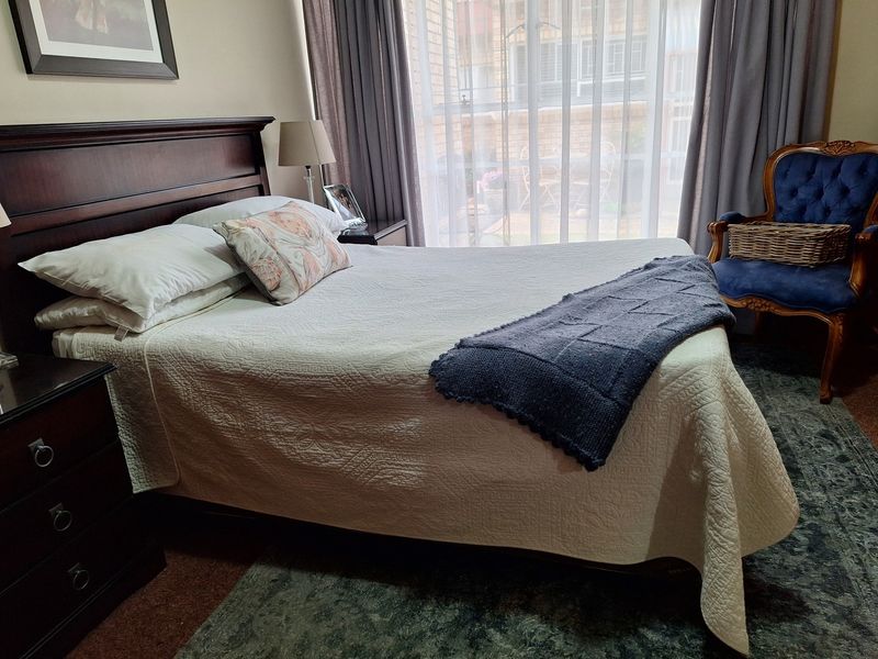 A well-maintained bedroom featuring a large sliding glass door that provides natural light and access to an outdoor area.