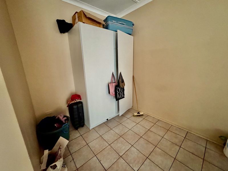 A bedroom featuring tiled flooring and a coved ceiling, providing a functional space ready for personalization.