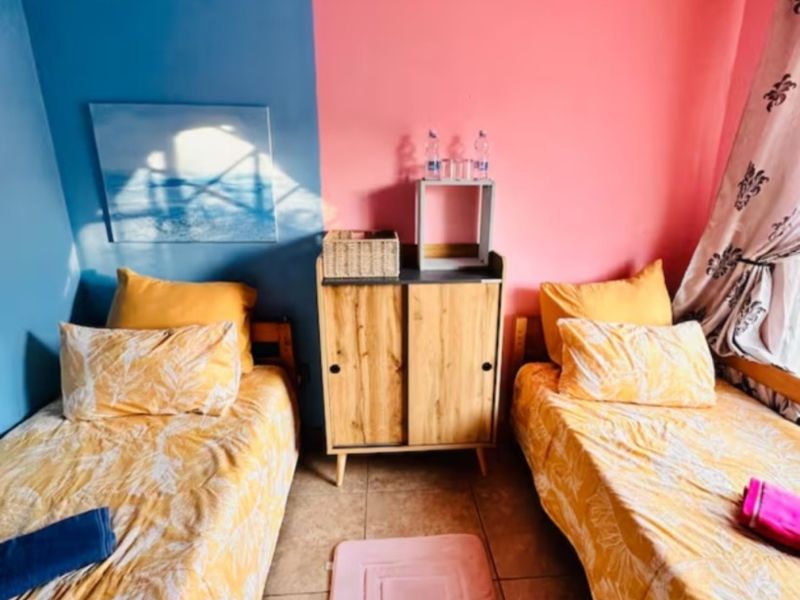 A bedroom featuring tiled flooring and a dual-tone painted wall finish.