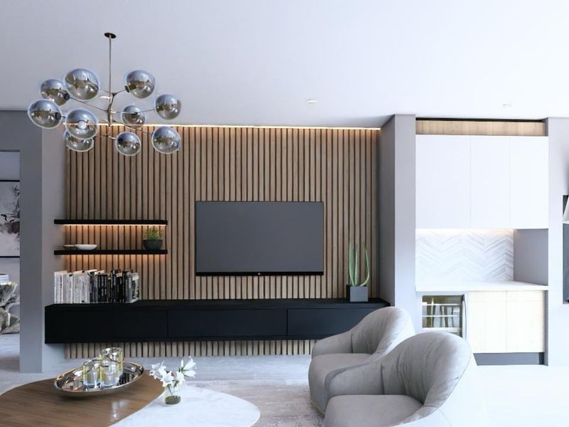 Modern living room featuring a striking slatted timber feature wall, built-in media console, integrated shelving, and a sleek fireplace with adjacent bar area.