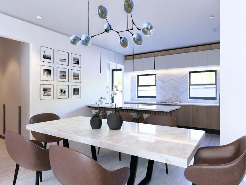Modern open-plan kitchen and dining area featuring a stone-topped island, herringbone backsplash, and contemporary cabinetry with integrated lighting.