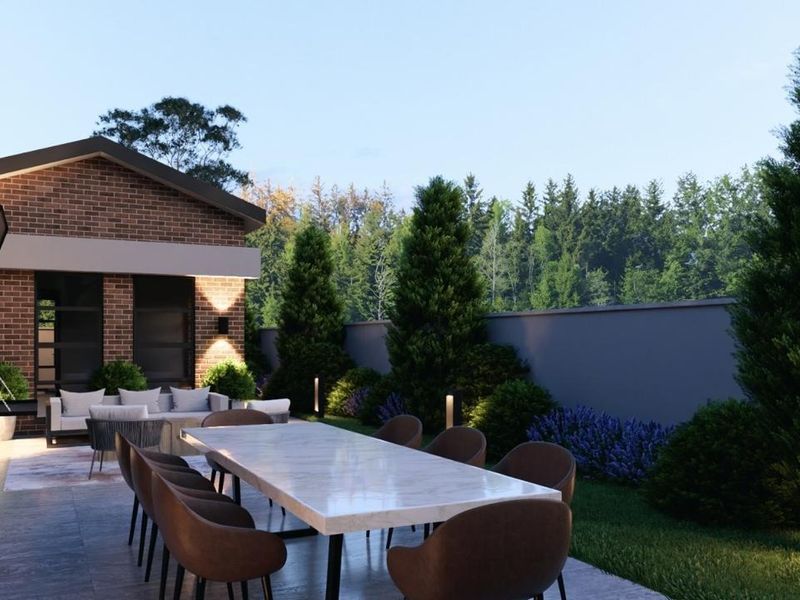 A modern outdoor patio area featuring brick architecture, paved flooring, and integrated exterior lighting, perfect for alfresco dining and relaxation.