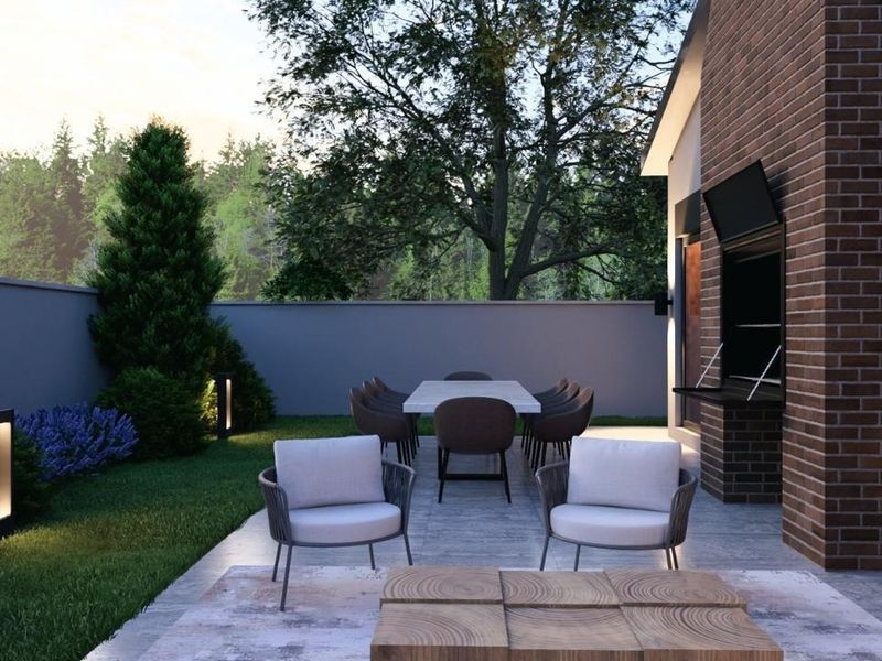 A modern outdoor patio featuring a built-in braai, brick chimney, and paved flooring, overlooking a landscaped garden with boundary wall and integrated lighting.