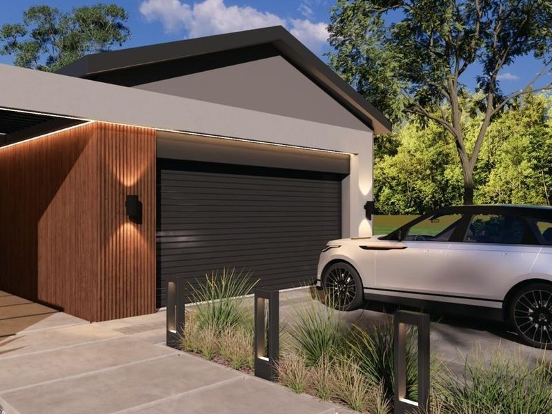 Modern front facade featuring a sleek garage door, timber slat accents, and integrated architectural lighting along the driveway.