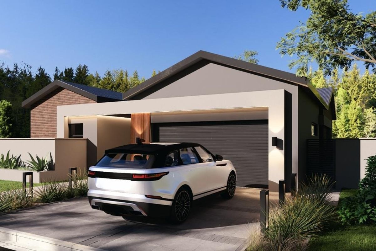 Modern residential front facade featuring a sleek garage, paved driveway, and contemporary architectural detailing with integrated exterior lighting.