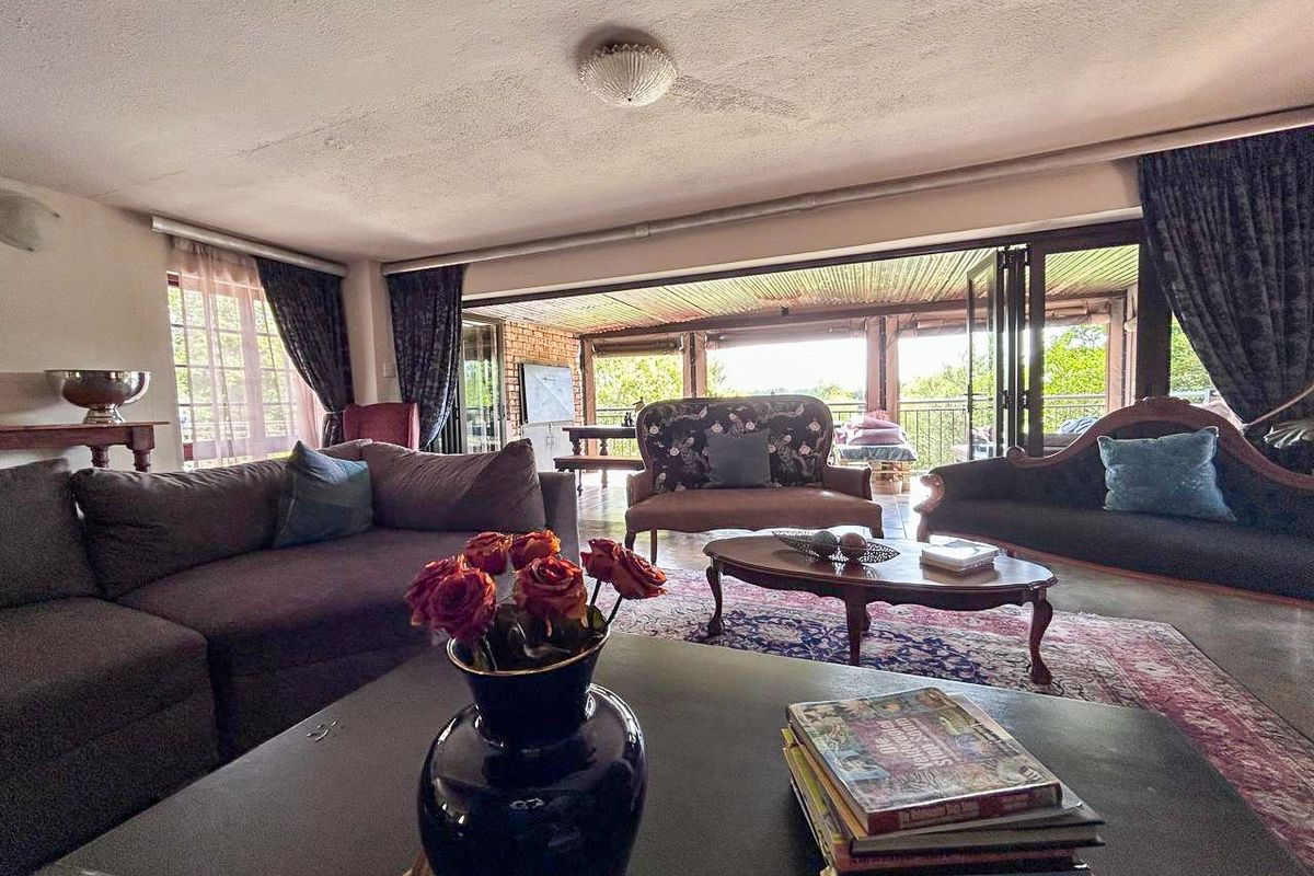 Spacious living room featuring large bi-fold doors that open onto a covered patio, providing seamless indoor-outdoor flow and natural light.