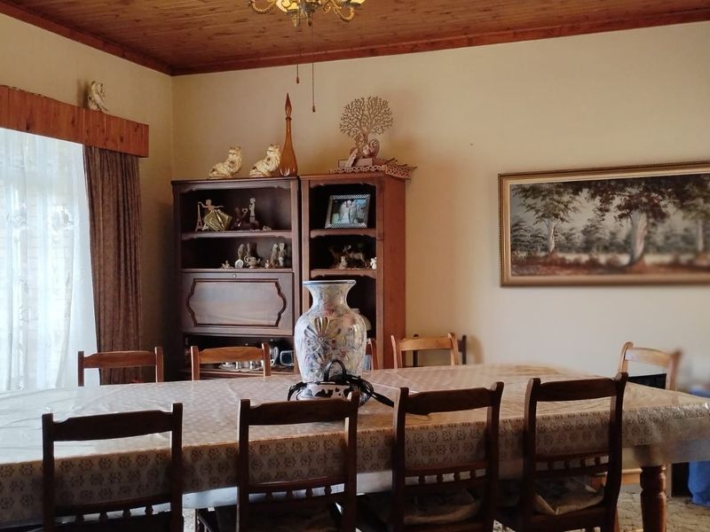 A traditional dining room featuring a warm timber ceiling and matching timber pelmet, providing a classic and cozy atmosphere for family meals.
