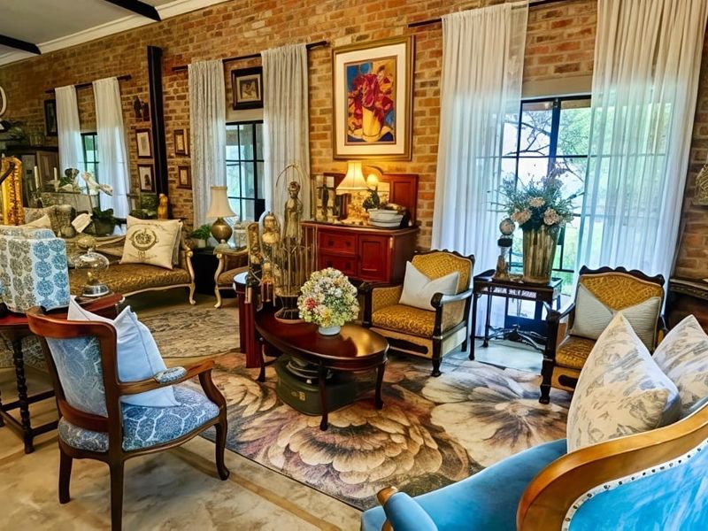 Spacious living room featuring characterful exposed brick walls, exposed ceiling beams, and large french doors providing ample natural light.