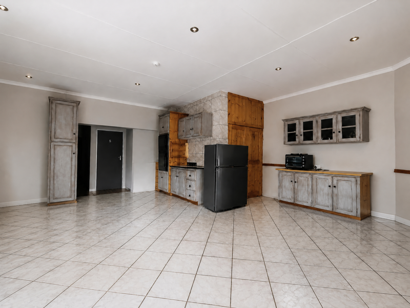 Spacious kitchen featuring tiled flooring, built-in cabinetry, and recessed lighting, offering a functional layout ready for modern updates.