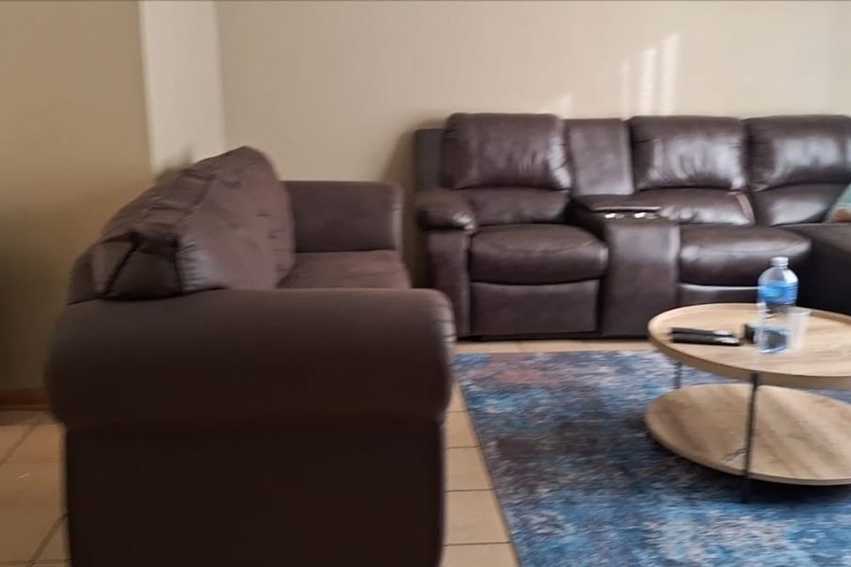 A living room area featuring tiled flooring and neutral wall finishes.
