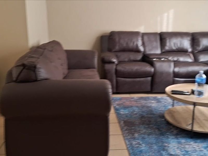 A living room area featuring tiled flooring and neutral wall finishes.