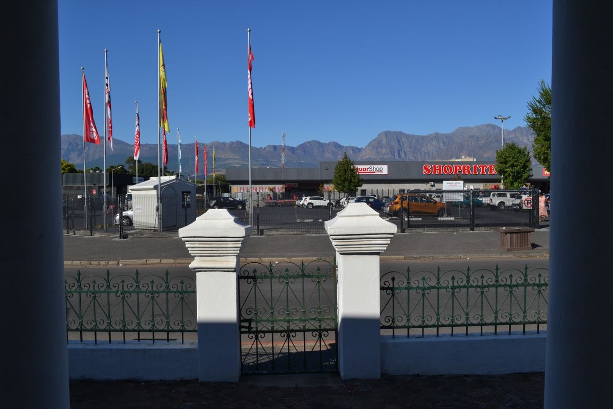 A view from the property looking out towards a commercial shopping center and mountain range in the distance.