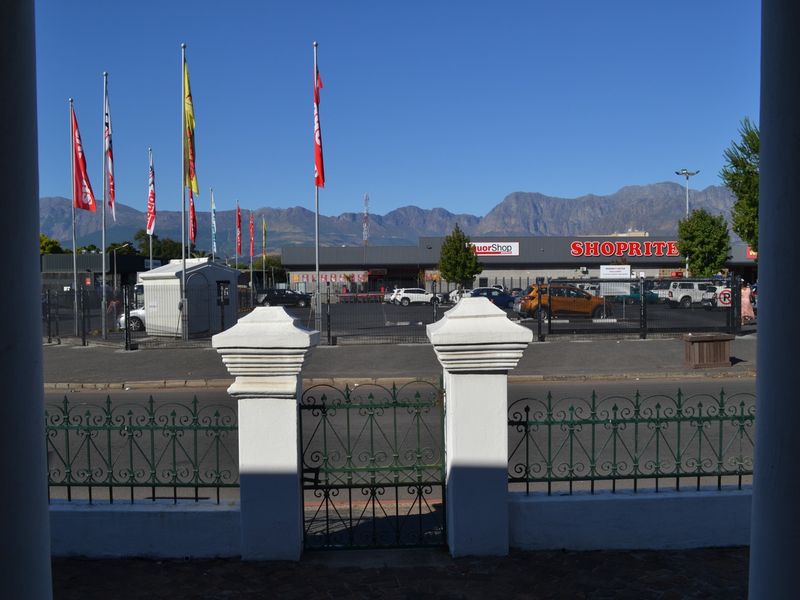 A view from the property looking out towards a commercial shopping center and mountain range in the distance.