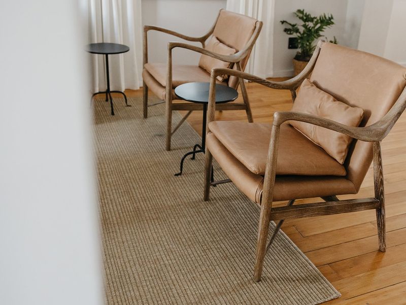 A bright living area featuring warm-toned hardwood flooring and neutral wall finishes, creating a comfortable and inviting space.