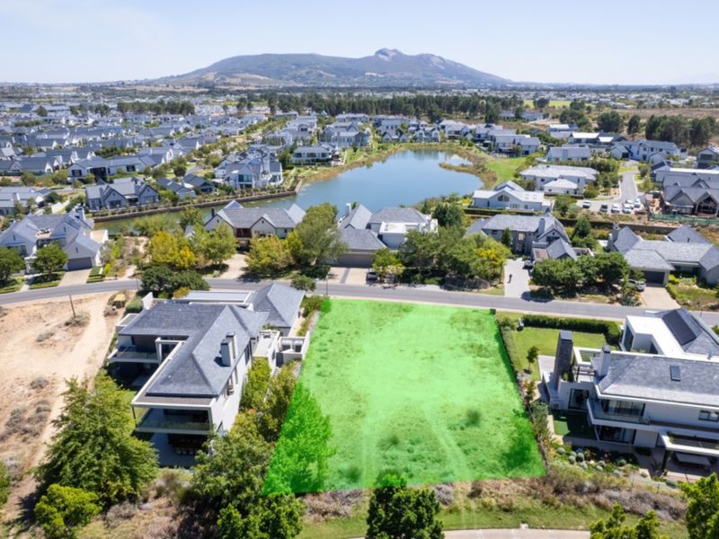 Aerial view of a vacant residential plot situated within a well-established estate, offering a prime opportunity for custom home development.