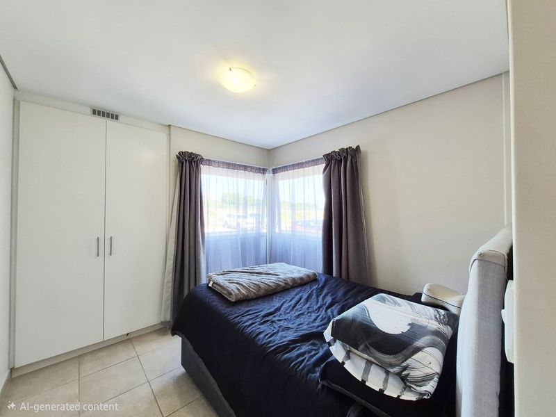 A bright bedroom featuring built-in wardrobes, tiled flooring, and corner windows that allow for natural light.